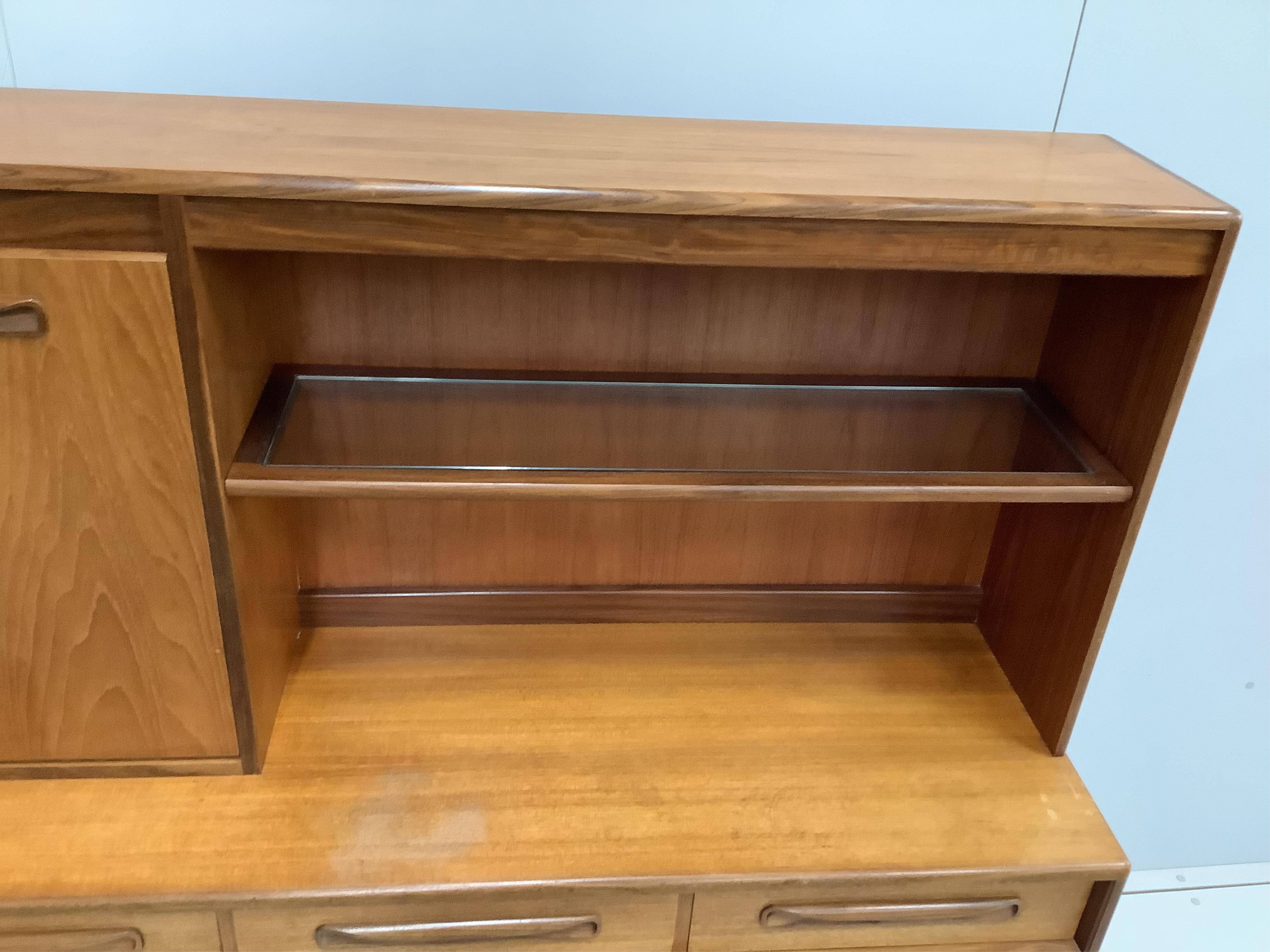 A mid century G Plan teak sideboard, width 142cm, depth 44cm, height 140cm. Condition - fair